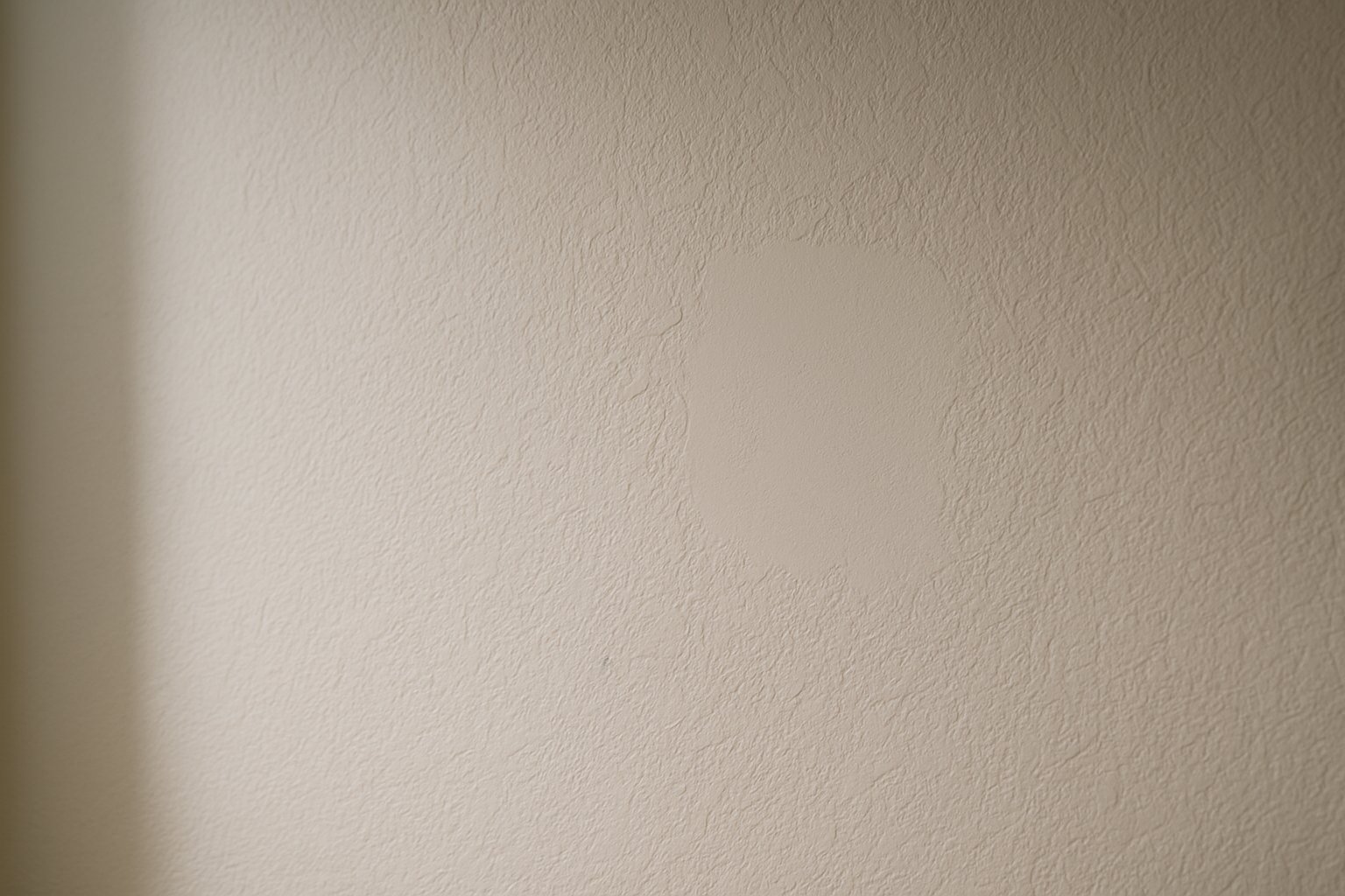 Subtle matched knockdown texture across a repaired wall